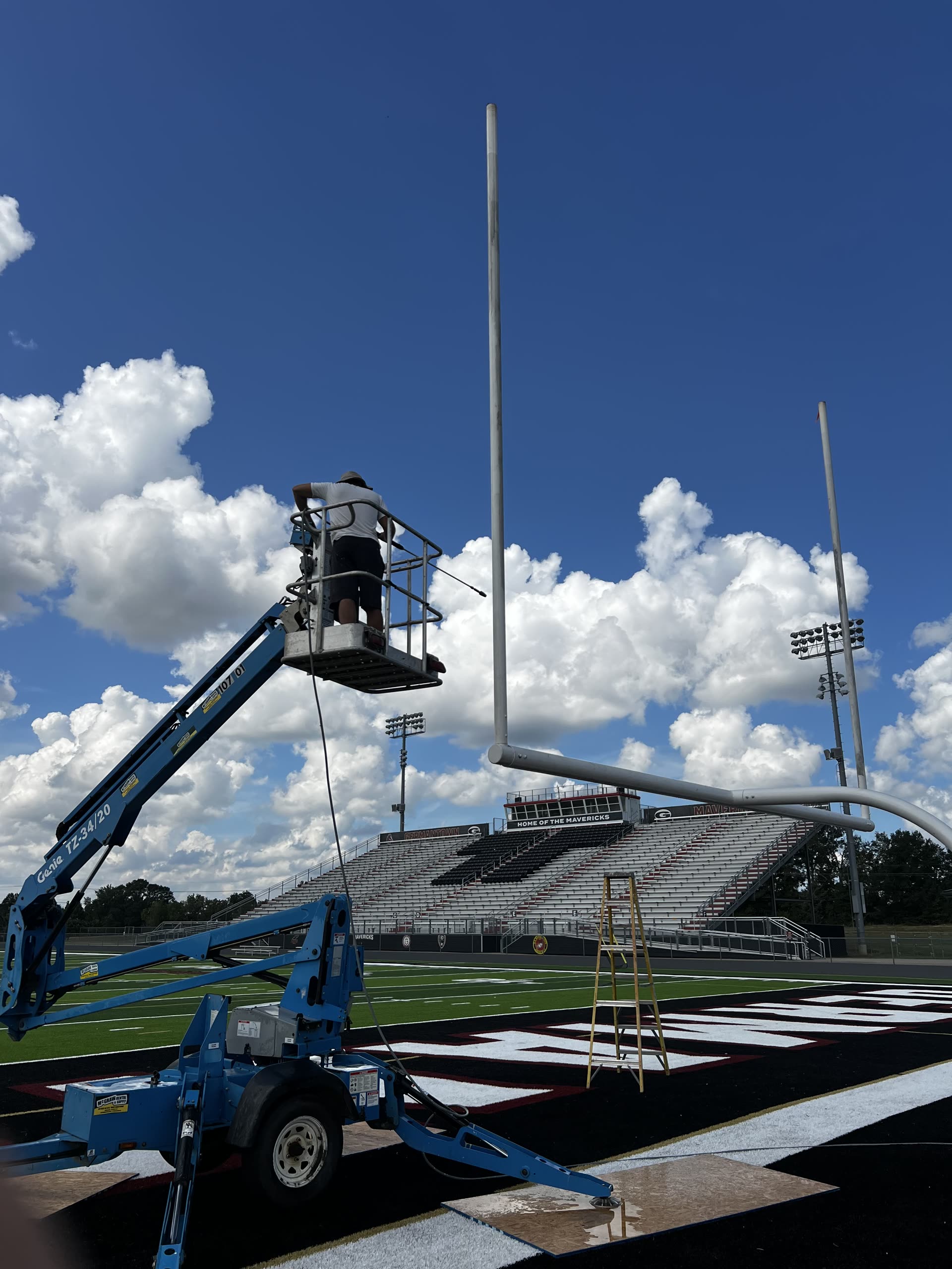 Boom lift pressure washing at stadium in Rankin County, Mississippi