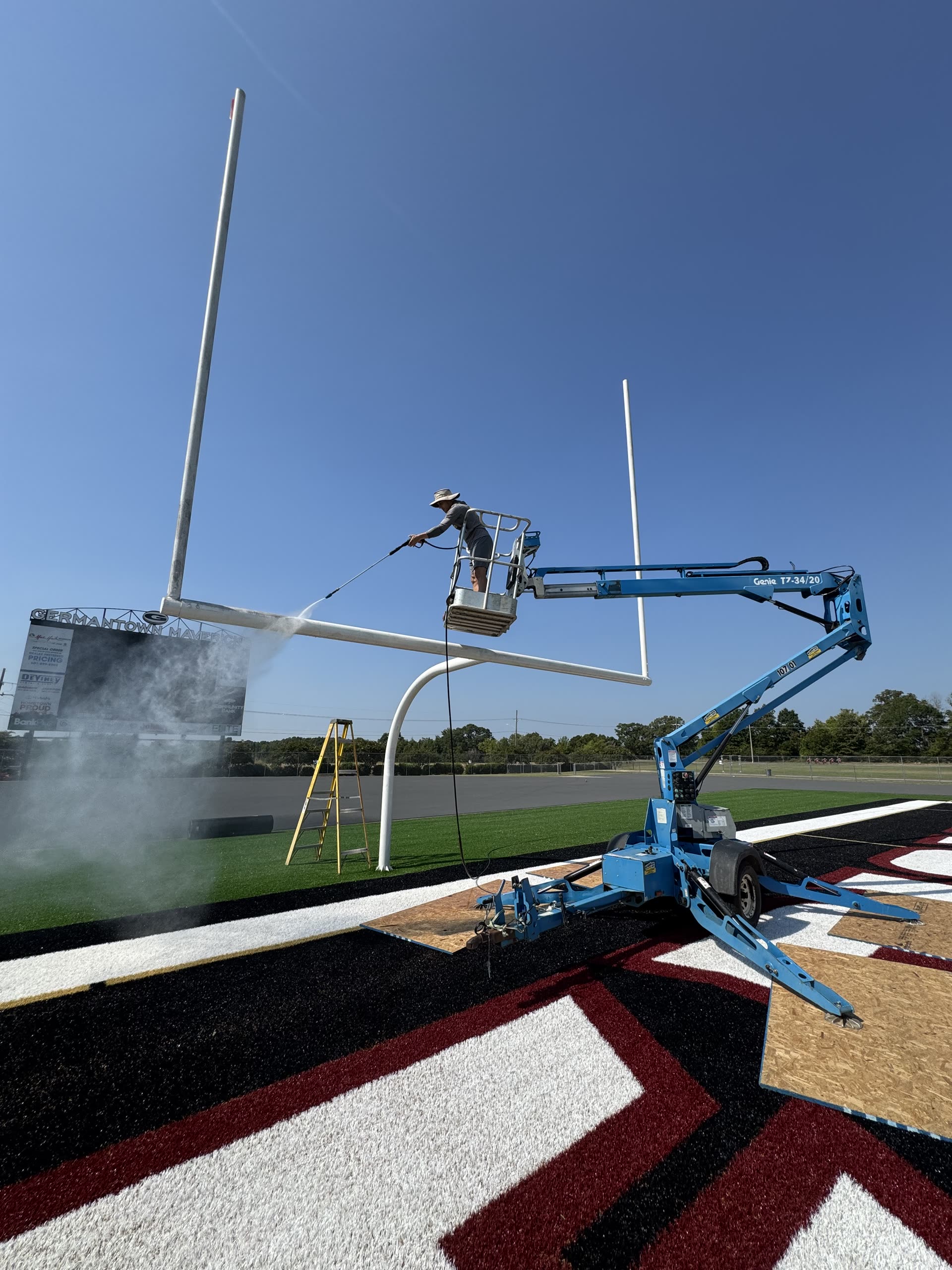Enhanced Home Care crew pressure washing at a stadium in Jackson Metro area